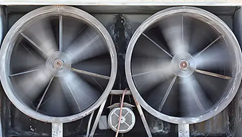 Two large fans are attached to a machine.